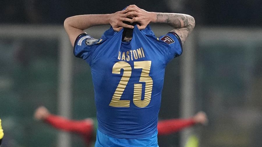 North Macedonia players celebrate as Italy's Alessandro Bastoni reacts after his team's got eliminated at the end of the World Cup qualifying play-off soccer match between Italy and North Macedonia, at Renzo Barbera stadium, in Palermo, Italy, Thursday, March 24, 2022. North Macedonia won 1-0. (AP Photo/Antonio Calanni)