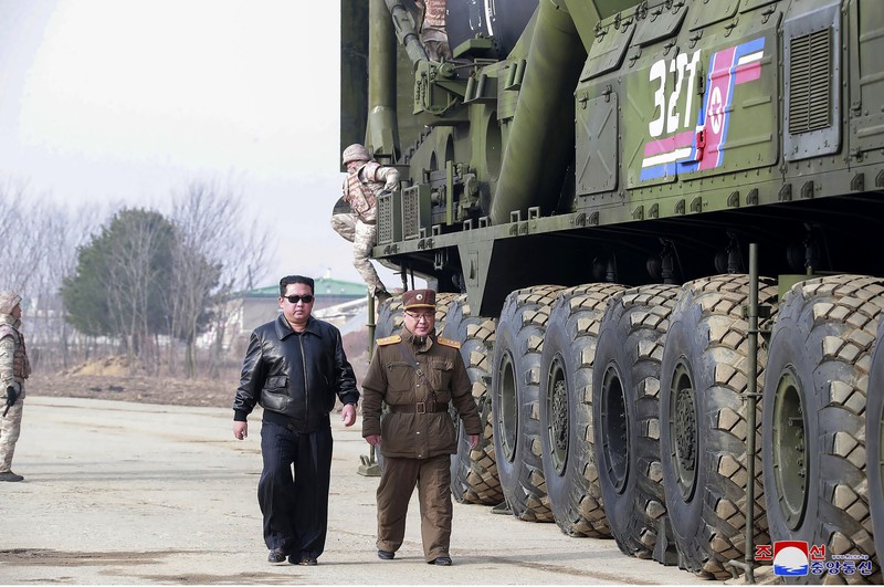 North Korea Koreas Tensions In this photo distributed by the North Korean government, North Korean leader Kim Jong Un, center, walks around what it says a Hwasong-17 intercontinental ballistic missile (ICBM) on the launcher, at an undisclosed location in North Korea on March 24, 2022. Independent journalists were not given access to cover the event depicted in this image distributed by the North Korean government. The content of this image is as provided and cannot be independently verified. Korean language watermark on image as provided by source reads: