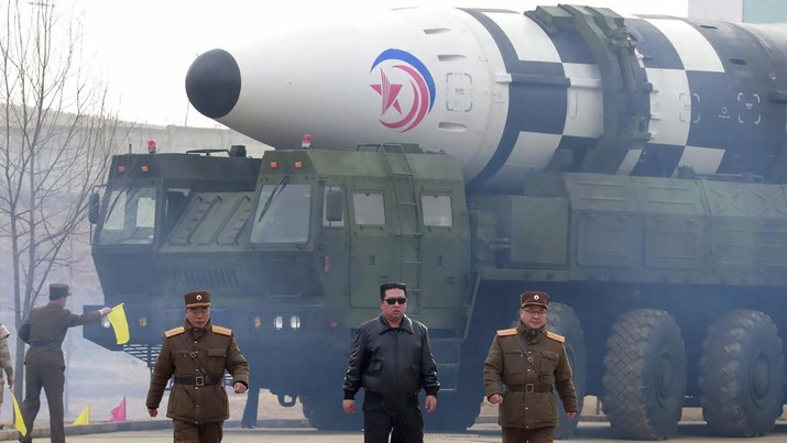 In this photo distributed by the North Korean government, North Korean leader Kim Jong Un, center, walks around what it says a Hwasong-17 intercontinental ballistic missile (ICBM) on the launcher, at an undisclosed location in North Korea on March 24, 2022. Independent journalists were not given access to cover the event depicted in this image distributed by the North Korean government. The content of this image is as provided and cannot be independently verified. Korean language watermark on image as provided by source reads: 