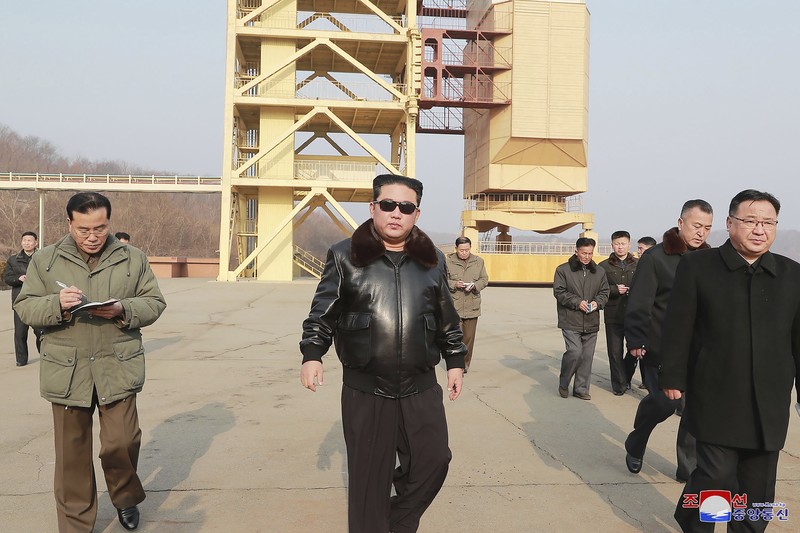 North Korea Koreas Tensions In this photo distributed by the North Korean government, North Korean leader Kim Jong Un, center, walks around what it says a Hwasong-17 intercontinental ballistic missile (ICBM) on the launcher, at an undisclosed location in North Korea on March 24, 2022. Independent journalists were not given access to cover the event depicted in this image distributed by the North Korean government. The content of this image is as provided and cannot be independently verified. Korean language watermark on image as provided by source reads:
