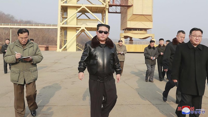 In this photo distributed by the North Korean government, North Korean leader Kim Jong Un, center, walks around what it says a Hwasong-17 intercontinental ballistic missile (ICBM) on the launcher, at an undisclosed location in North Korea on March 24, 2022. Independent journalists were not given access to cover the event depicted in this image distributed by the North Korean government. The content of this image is as provided and cannot be independently verified. Korean language watermark on image as provided by source reads: 