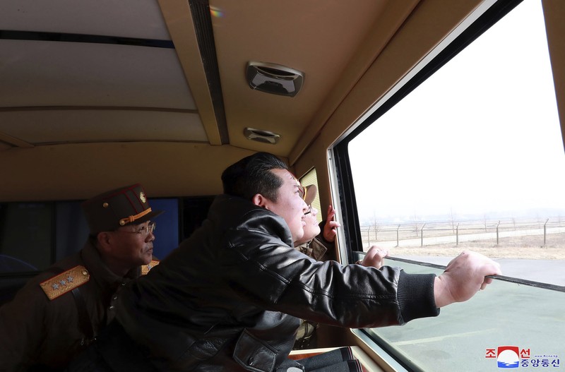 North Korea Koreas Tensions In this photo distributed by the North Korean government, North Korean leader Kim Jong Un, center, walks around what it says a Hwasong-17 intercontinental ballistic missile (ICBM) on the launcher, at an undisclosed location in North Korea on March 24, 2022. Independent journalists were not given access to cover the event depicted in this image distributed by the North Korean government. The content of this image is as provided and cannot be independently verified. Korean language watermark on image as provided by source reads: