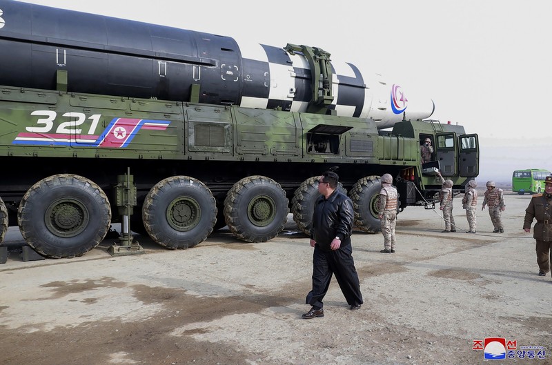 North Korea Koreas Tensions In this photo distributed by the North Korean government, North Korean leader Kim Jong Un, center, walks around what it says a Hwasong-17 intercontinental ballistic missile (ICBM) on the launcher, at an undisclosed location in North Korea on March 24, 2022. Independent journalists were not given access to cover the event depicted in this image distributed by the North Korean government. The content of this image is as provided and cannot be independently verified. Korean language watermark on image as provided by source reads: