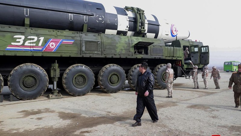 In this photo distributed by the North Korean government, North Korean leader Kim Jong Un, center, walks around what it says a Hwasong-17 intercontinental ballistic missile (ICBM) on the launcher, at an undisclosed location in North Korea on March 24, 2022. Independent journalists were not given access to cover the event depicted in this image distributed by the North Korean government. The content of this image is as provided and cannot be independently verified. Korean language watermark on image as provided by source reads: 