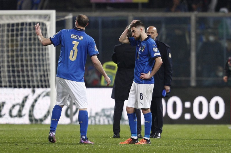North Macedonia players celebrate as Italy's Alessandro Bastoni reacts after his team's got eliminated at the end of the World Cup qualifying play-off soccer match between Italy and North Macedonia, at Renzo Barbera stadium, in Palermo, Italy, Thursday, March 24, 2022. North Macedonia won 1-0. (AP Photo/Antonio Calanni)