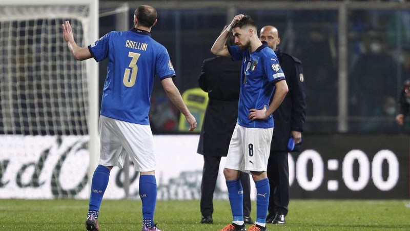 North Macedonia players celebrate as Italy's Alessandro Bastoni reacts after his team's got eliminated at the end of the World Cup qualifying play-off soccer match between Italy and North Macedonia, at Renzo Barbera stadium, in Palermo, Italy, Thursday, March 24, 2022. North Macedonia won 1-0. (AP Photo/Antonio Calanni)