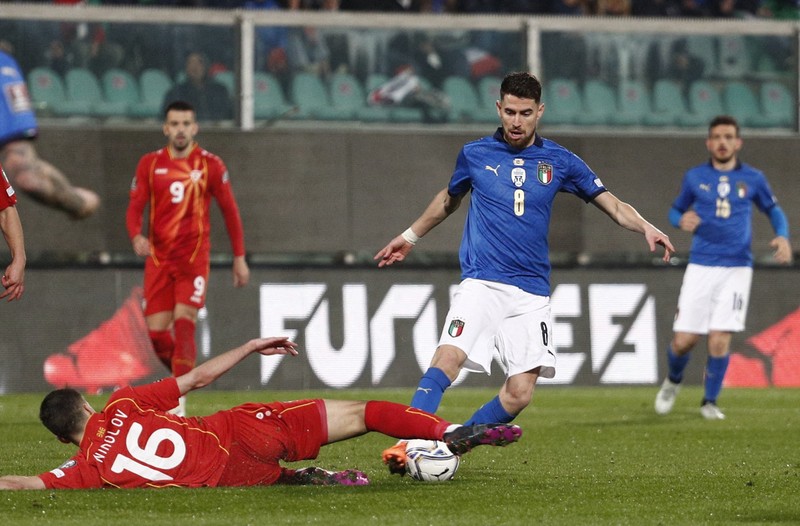 North Macedonia players celebrate as Italy's Alessandro Bastoni reacts after his team's got eliminated at the end of the World Cup qualifying play-off soccer match between Italy and North Macedonia, at Renzo Barbera stadium, in Palermo, Italy, Thursday, March 24, 2022. North Macedonia won 1-0. (AP Photo/Antonio Calanni)