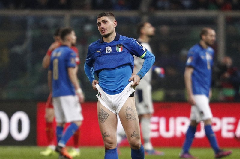 North Macedonia players celebrate as Italy's Alessandro Bastoni reacts after his team's got eliminated at the end of the World Cup qualifying play-off soccer match between Italy and North Macedonia, at Renzo Barbera stadium, in Palermo, Italy, Thursday, March 24, 2022. North Macedonia won 1-0. (AP Photo/Antonio Calanni)