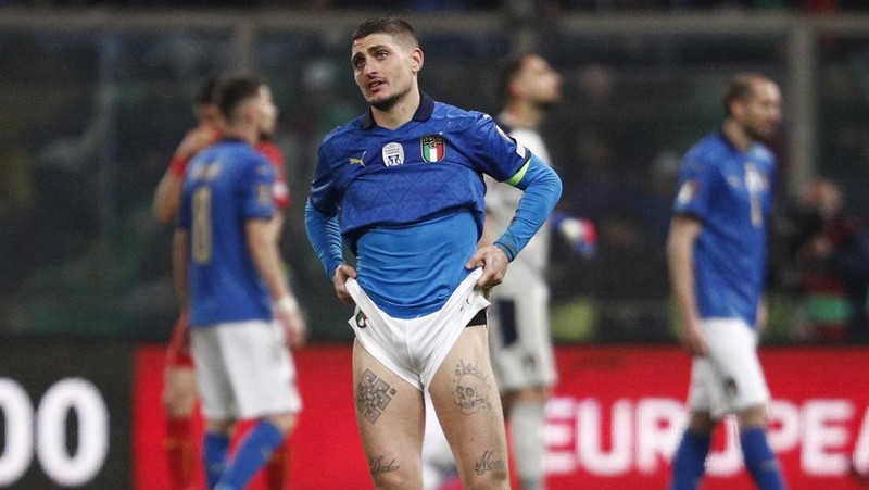 North Macedonia players celebrate as Italy's Alessandro Bastoni reacts after his team's got eliminated at the end of the World Cup qualifying play-off soccer match between Italy and North Macedonia, at Renzo Barbera stadium, in Palermo, Italy, Thursday, March 24, 2022. North Macedonia won 1-0. (AP Photo/Antonio Calanni)