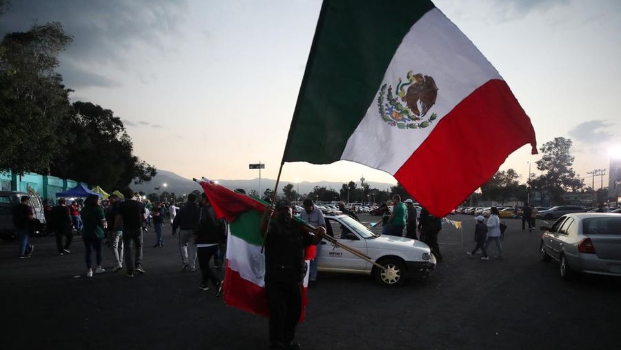 Soccer Football - World Cup - Concacaf Qualifiers - Mexico v United States - Estadio Azteca, Mexico City, Mexico - March 24, 2022 A vendor sells Mexico flags outside the stadium before the match REUTERS/Henry Romero