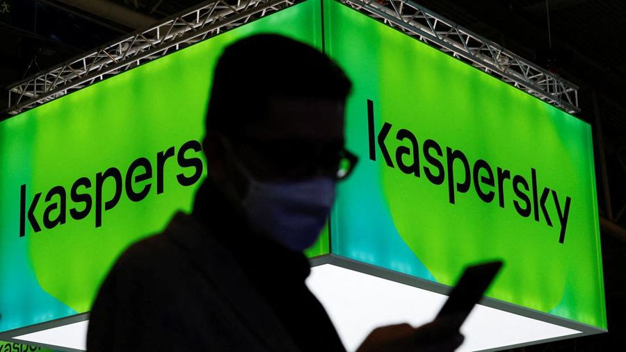 A man walks next to Russian Kaspersky stand during the GSMA's 2022 Mobile World Congress (MWC), in Barcelona, Spain, March 2, 2022. REUTERS/ Albert Gea