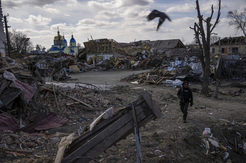 Seorang prajurit Ukraina berjalan di luar gedung administrasi regional, yang rusak berat setelah serangan Rusia awal bulan ini di Kharkiv, Ukraina, Minggu (27/3/2022). (AP Photo/Felipe Dana)