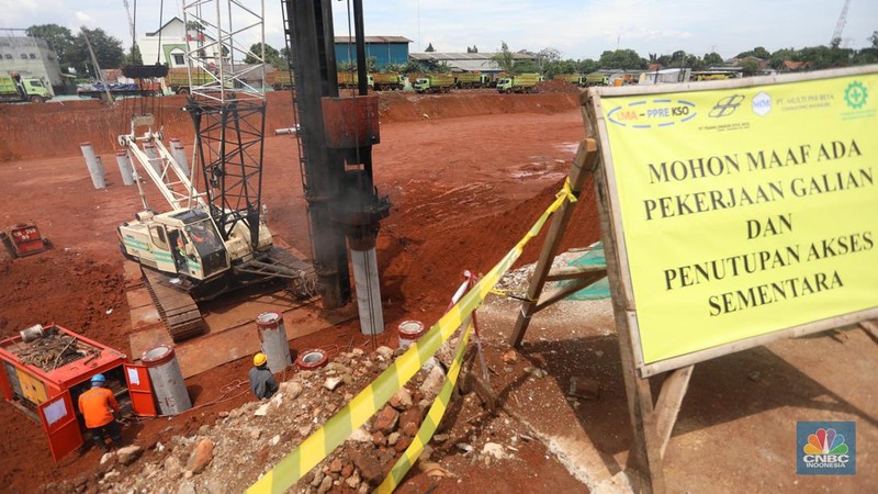 Pekerja dengan menngunakan alat berat memasang tiang pancang pada proyek alan Tol Cinere-Jagorawi Seksi 3 Limo-Kukusan di kawasan Limo, Depok, Jawa Barar, Jumat (8/4/2022). ( CNBC Indonesia/Andrean Kristianto)
