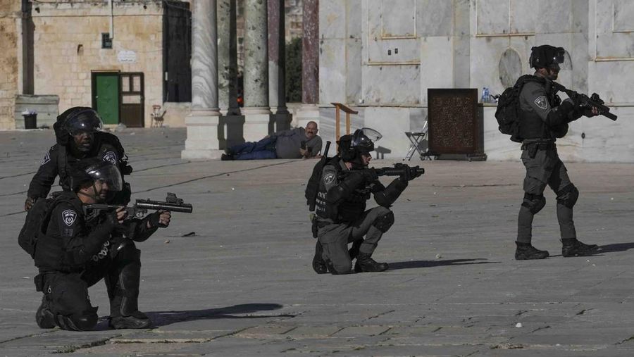 Palestinians clash with Israeli security forces at the Al Aqsa Mosque compound in Jerusalem's Old City Friday, April 15, 2022. (AP Photo/Mahmoud Illean)