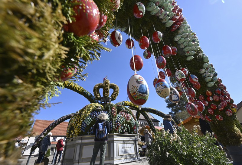 Batman and Spiderman climb down the facade to deliver chocolate eggs for Easter to the children hospitalized in the De Marchi Pediatric Clinic in Milan, Italy, Thursday, April 14, 2022. (LaPresse via AP)