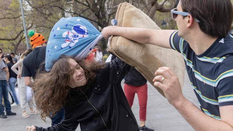 People take part in the International Pillow Fight Day at Washington Square Park in Manhattan, New York, U.S., April 16, 2022. REUTERS/Jeenah Moon