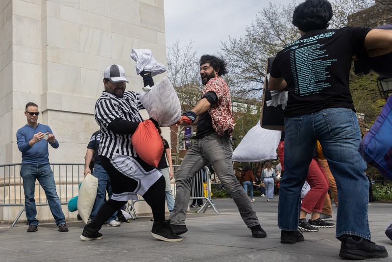 People take part in the International Pillow Fight Day at Washington Square Park in Manhattan, New York, U.S., April 16, 2022. REUTERS/Jeenah Moon