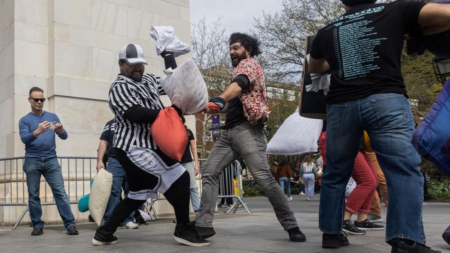 People take part in the International Pillow Fight Day at Washington Square Park in Manhattan, New York, U.S., April 16, 2022. REUTERS/Jeenah Moon