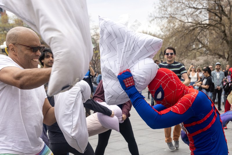People take part in the International Pillow Fight Day at Washington Square Park in Manhattan, New York, U.S., April 16, 2022. REUTERS/Jeenah Moon