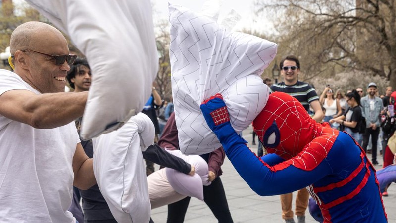 People take part in the International Pillow Fight Day at Washington Square Park in Manhattan, New York, U.S., April 16, 2022. REUTERS/Jeenah Moon