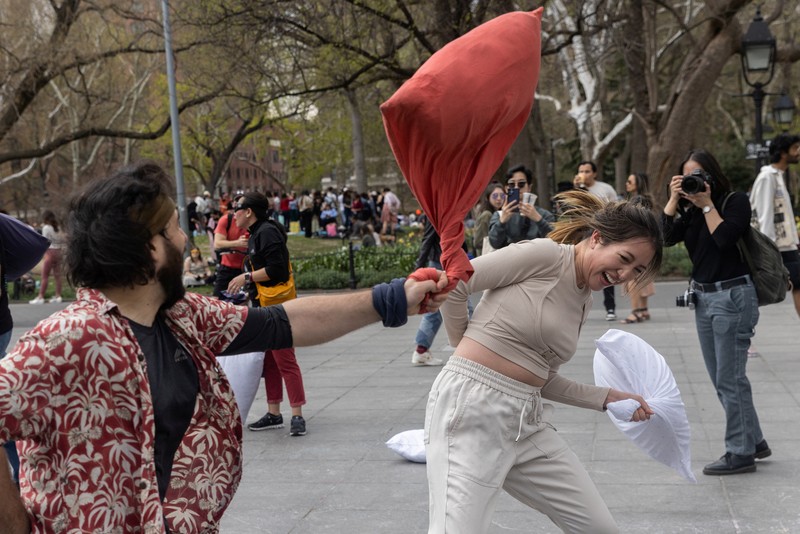 People take part in the International Pillow Fight Day at Washington Square Park in Manhattan, New York, U.S., April 16, 2022. REUTERS/Jeenah Moon