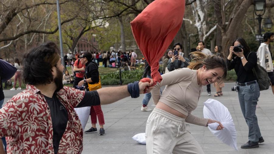 People take part in the International Pillow Fight Day at Washington Square Park in Manhattan, New York, U.S., April 16, 2022. REUTERS/Jeenah Moon