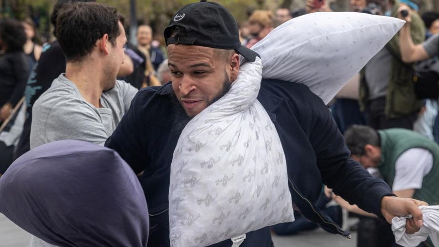 People take part in the International Pillow Fight Day at Washington Square Park in Manhattan, New York, U.S., April 16, 2022. REUTERS/Jeenah Moon
