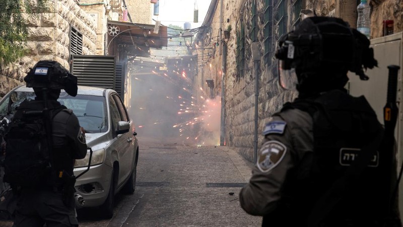 Israeli Border police officers run in an alley in Jerusalem's Old City April 17, 2022. REUTERS/Ammar Awad