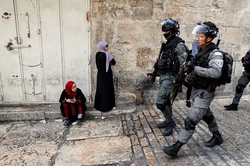 ISRAEL-PALESTINIANS/VIOLENCE Israeli Border police officers run in an alley in Jerusalem's Old City April 17, 2022. REUTERS/Ammar Awad