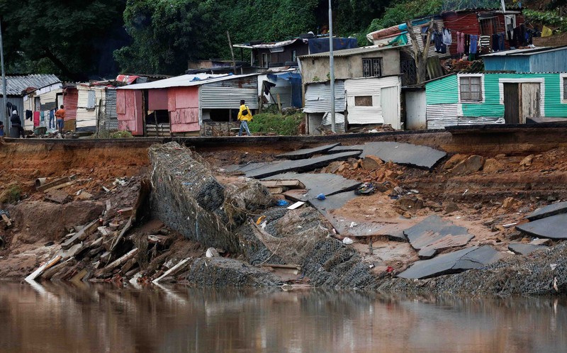 SAFRICA-FLOODS/ A search and rescue team member uses a dog to search for bodies in Dassenhoek near Durban, South Africa, April 17, 2022. REUTERS/Rogan Ward