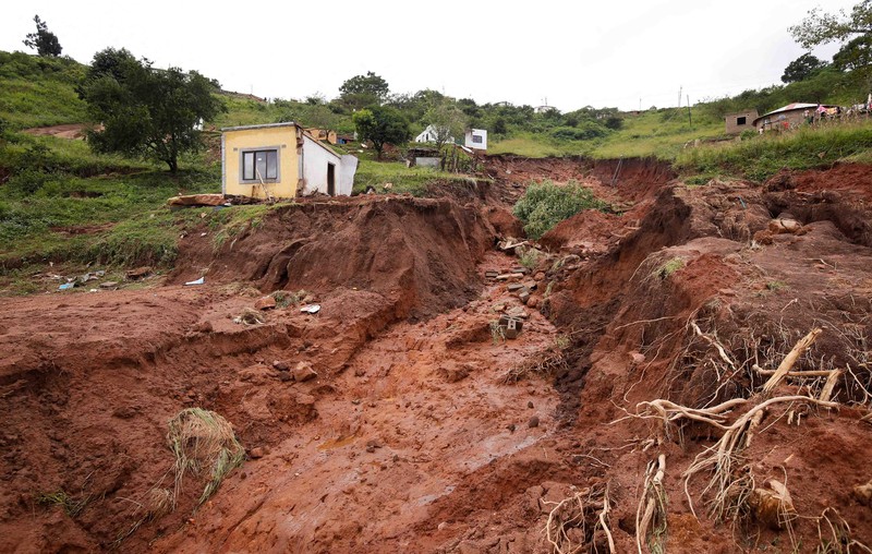 A search and rescue team member uses a dog to search for bodies in Dassenhoek near Durban, South Africa, April 17, 2022. REUTERS/Rogan Ward