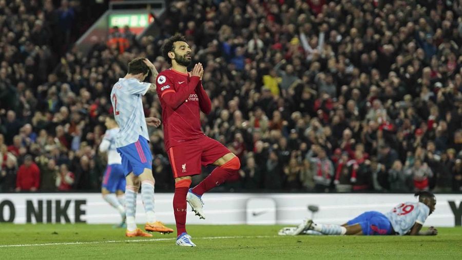 Liverpool's Mohamed Salah, fifth left, celebrates with his teammates after scoring his side's second goal during the English Premier League soccer match between Liverpool and Manchester United at Anfield stadium in Liverpool, England, Tuesday, April 19, 2022. (AP Photo/Jon Super)