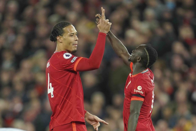 Britain Soccer Premier League Liverpool's Mohamed Salah, fifth left, celebrates with his teammates after scoring his side's second goal during the English Premier League soccer match between Liverpool and Manchester United at Anfield stadium in Liverpool, England, Tuesday, April 19, 2022. (AP Photo/Jon Super)