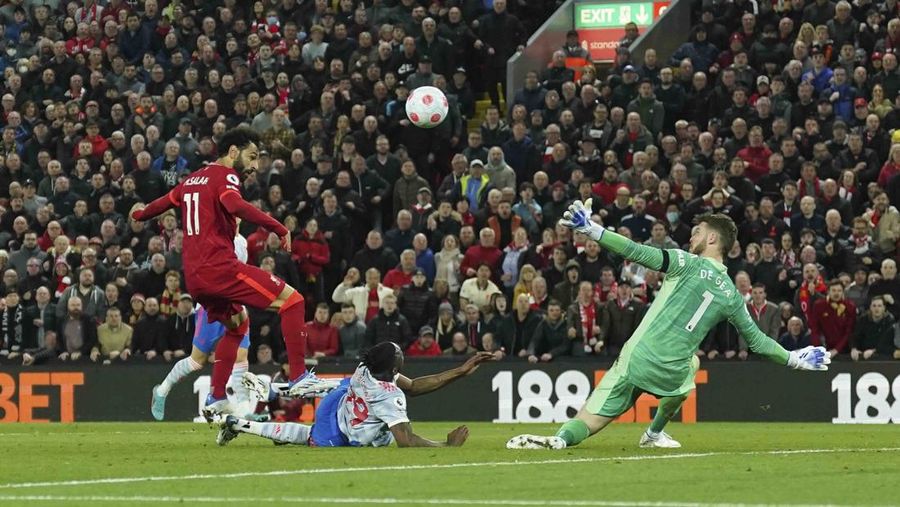 Liverpool's Mohamed Salah, fifth left, celebrates with his teammates after scoring his side's second goal during the English Premier League soccer match between Liverpool and Manchester United at Anfield stadium in Liverpool, England, Tuesday, April 19, 2022. (AP Photo/Jon Super)