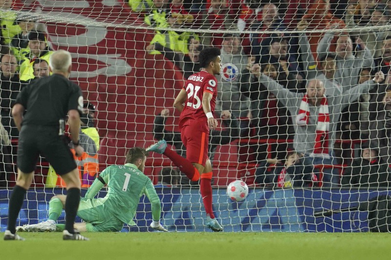 Britain Soccer Premier League Liverpool's Mohamed Salah, fifth left, celebrates with his teammates after scoring his side's second goal during the English Premier League soccer match between Liverpool and Manchester United at Anfield stadium in Liverpool, England, Tuesday, April 19, 2022. (AP Photo/Jon Super)