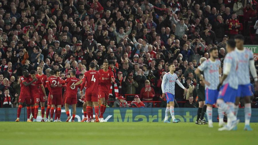Liverpool's Mohamed Salah, fifth left, celebrates with his teammates after scoring his side's second goal during the English Premier League soccer match between Liverpool and Manchester United at Anfield stadium in Liverpool, England, Tuesday, April 19, 2022. (AP Photo/Jon Super)
