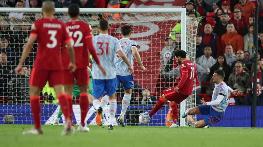 Liverpool's Mohamed Salah, fifth left, celebrates with his teammates after scoring his side's second goal during the English Premier League soccer match between Liverpool and Manchester United at Anfield stadium in Liverpool, England, Tuesday, April 19, 2022. (AP Photo/Jon Super)