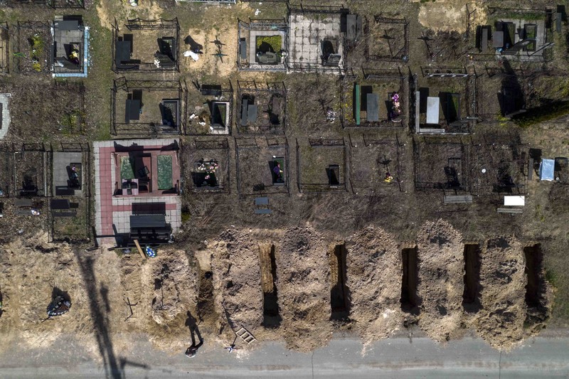 Russia Ukraine War A general view of the cemetery in Irpin where three dug graves await the next funerals on Tuesday, April 19, 2022, in the outskirts of Kyiv. (AP Photo/Emilio Morenatti)