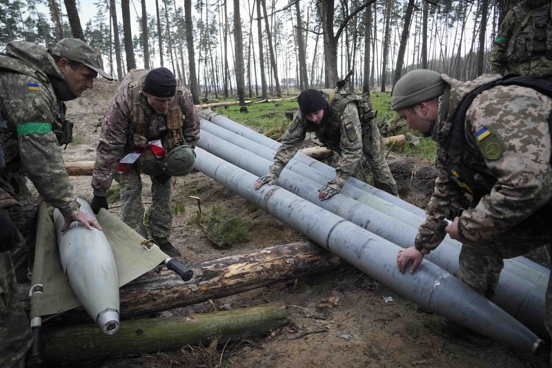 Russia Ukraine War Ukrainian soldiers examine Russian multiple missiles abandoned by Russian troops, in the village of Berezivka, Ukraine, Thursday, April 21, 2022. (AP Photo/Efrem Lukatsky)