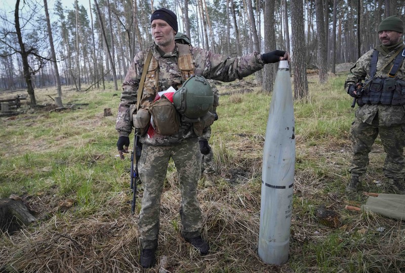 Ukrainian soldiers examine Russian multiple missiles abandoned by Russian troops, in the village of Berezivka, Ukraine, Thursday, April 21, 2022. (AP Photo/Efrem Lukatsky)