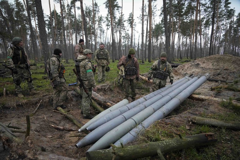 Russia Ukraine War Ukrainian soldiers examine Russian multiple missiles abandoned by Russian troops, in the village of Berezivka, Ukraine, Thursday, April 21, 2022. (AP Photo/Efrem Lukatsky)