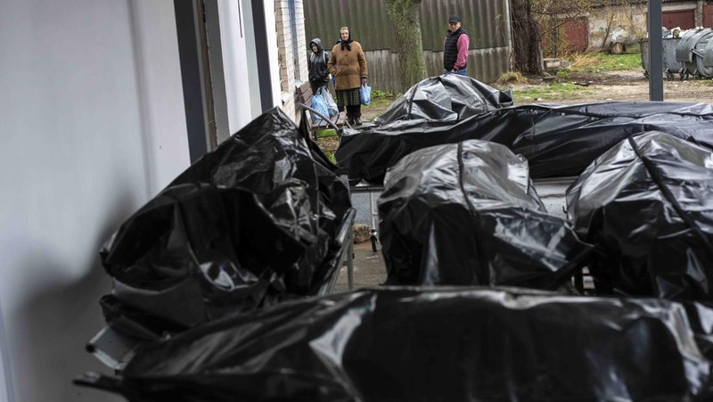 A general view of the cemetery in Irpin where three dug graves await the next funerals on Tuesday, April 19, 2022, in the outskirts of Kyiv. (AP Photo/Emilio Morenatti)