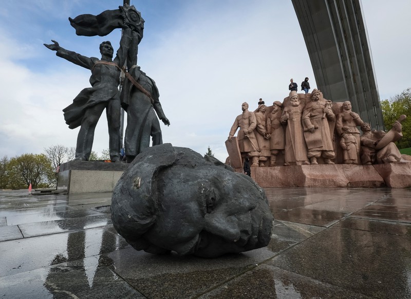 Pekerja membongkar monumen Soviet untuk persahabatan Ukraina-Rusia, di tengah invasi Rusia ke Ukraina. (REUTERS/GLEB GARANICH)