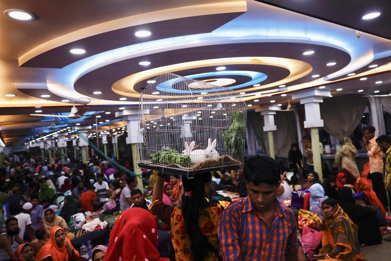 RELIGION-EID/BANGLADESH People sit onboard passenger ferries to travel home to celebrate Eid al-fitr, at the Sadarghat Launch Terminal, in Dhaka, Bangladesh, April 30, 2022. REUTERS/Mohammad Ponir Hossain