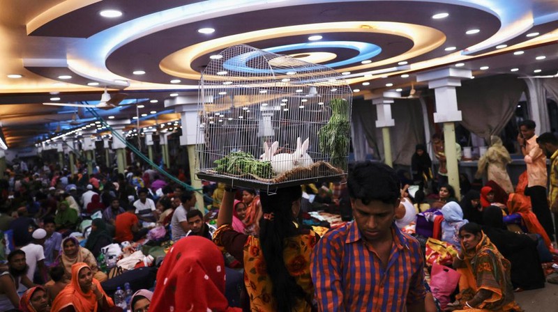 People sit onboard passenger ferries to travel home to celebrate Eid al-fitr, at the Sadarghat Launch Terminal, in Dhaka, Bangladesh, April 30, 2022. REUTERS/Mohammad Ponir Hossain