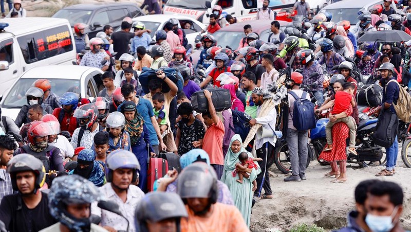 People sit onboard passenger ferries to travel home to celebrate Eid al-fitr, at the Sadarghat Launch Terminal, in Dhaka, Bangladesh, April 30, 2022. REUTERS/Mohammad Ponir Hossain