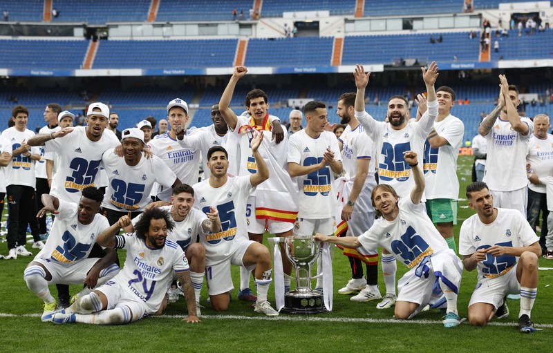 Soccer Football - LaLiga - Real Madrid v Espanyol - Santiago Bernabeu, Madrid, Spain - April 30, 2022 Real Madrid team members celebrate with the trophy after winning LaLiga REUTERS/Susana Vera