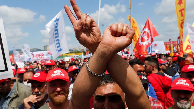 Petugas kepolisian menahan seorang pengunjuk rasa yang menggelar unjuk rasa May Day di Lapangan Taksim di Istanbul, Turki, Minggu (1/5/2022). (REUTERS/Kemal Aslan)