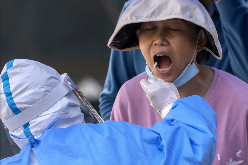 Warga mengendarai sepeda di Central Business District (CBD) saat pemerintah menerapkan perintah kerja dari rumah bagi penduduk distrik Chaoyang di tengah wabah penyakit coronavirus (COVID-19), di Beijing, China, Kamis (5/4/2022). (REUTERS/Tingshu Wang)