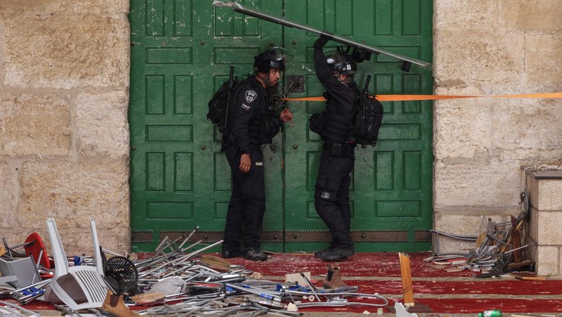 Pasukan keamanan Israel berjaga di dekat sebuah pintu di kompleks Masjid Al-Aqsa di Kota Tua Yerusalem, Kamis (5/4/2022). (REUTERS/Ammar Awad)